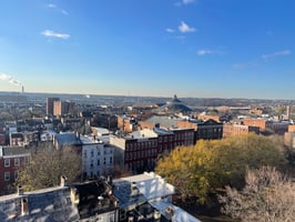 Aerial view of downtown Maryland buildings in the sunlight, representing Zerodraft Maryland’s large-scale urban energy efficiency projects.